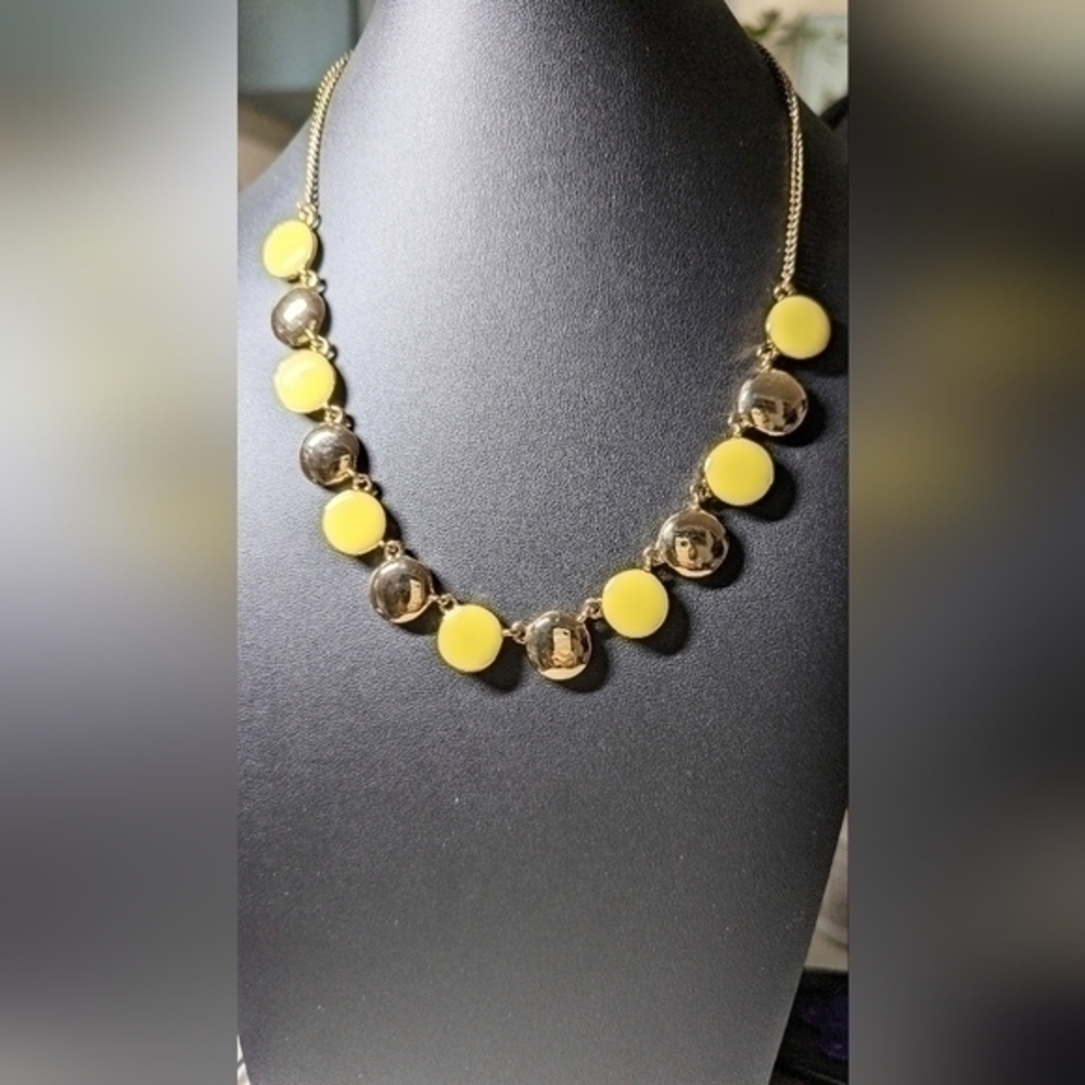 A Macy's yellow and gold color necklace. NWT.